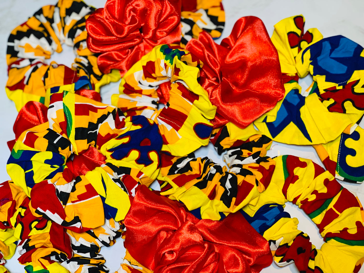 8 Different Colored Scrunchies including Red, Deep Blue , White , Wine And Sea Blue Large Scrunchie , One Purple Green And Yellow Large Scrunchie And One Red ,Yellow , Blue, Black And Green large Scrunchie