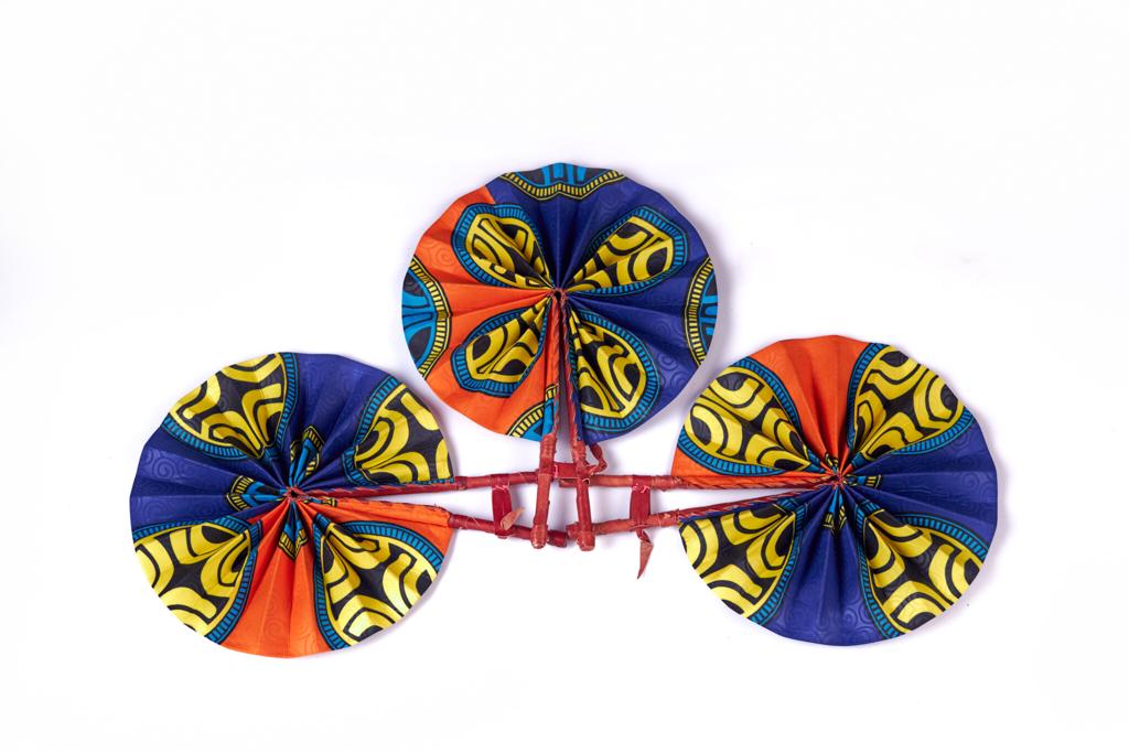 Foldable and Portable Bogolan Print Made of Orange, Yellow,Black And Blue Well Designed Colours Ghana Made Handfans With Leather Handle.