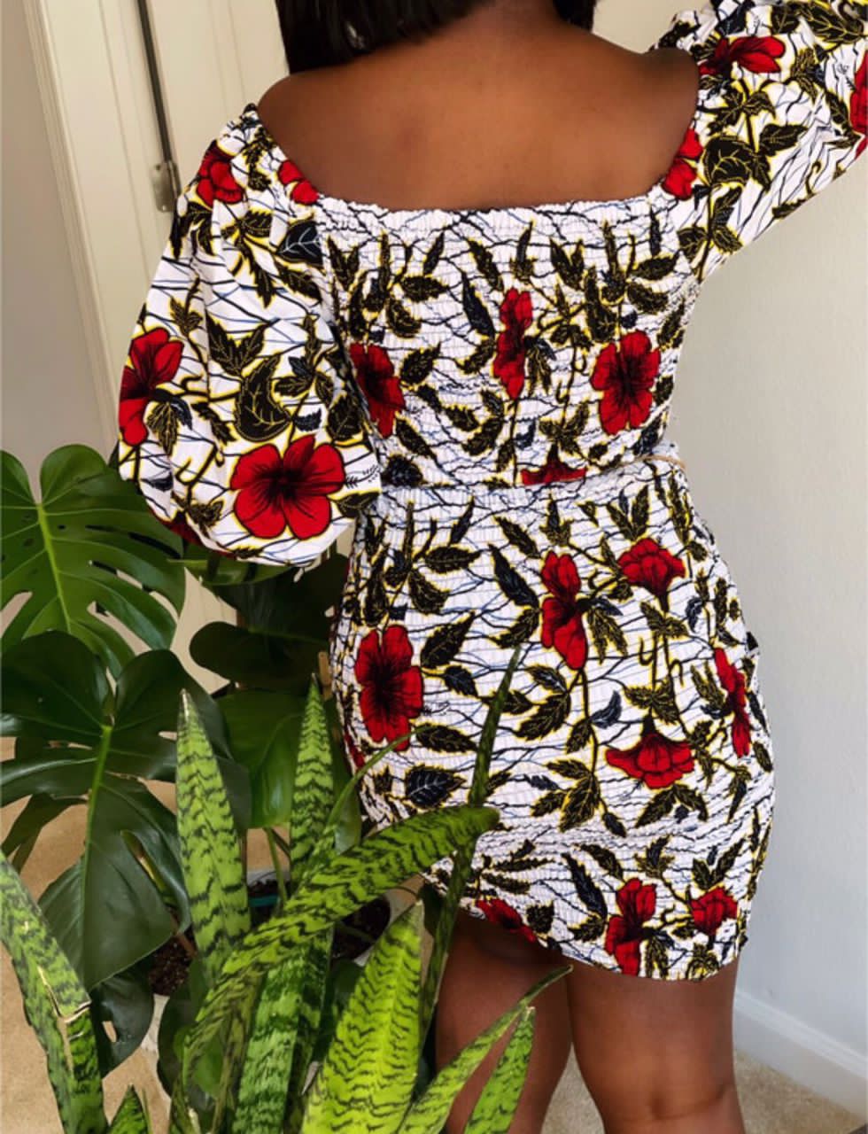 A stretchy two piece short skirt and a quarter sleeve puff hand top made with Ankara wax print/fabric designed with white, black gold and red beautiful 🌹colours and pattern