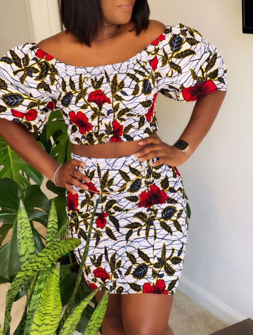 A stretchy two piece short skirt and a quarter sleeve puff hand top made with Ankara wax print/fabric designed with white, black gold and red beautiful 🌹colours and pattern