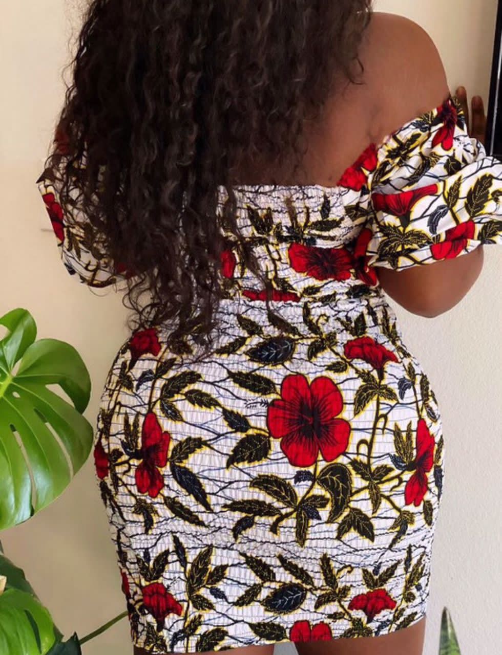A stretchy two piece short skirt and a quarter sleeve puff hand top made with Ankara wax print/fabric designed with white, black gold and red beautiful 🌹colours and pattern