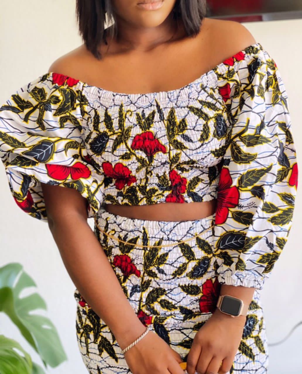 A stretchy two piece short skirt and a quarter sleeve puff hand top made with Ankara wax print/fabric designed with white, black gold and red beautiful 🌹colours and pattern