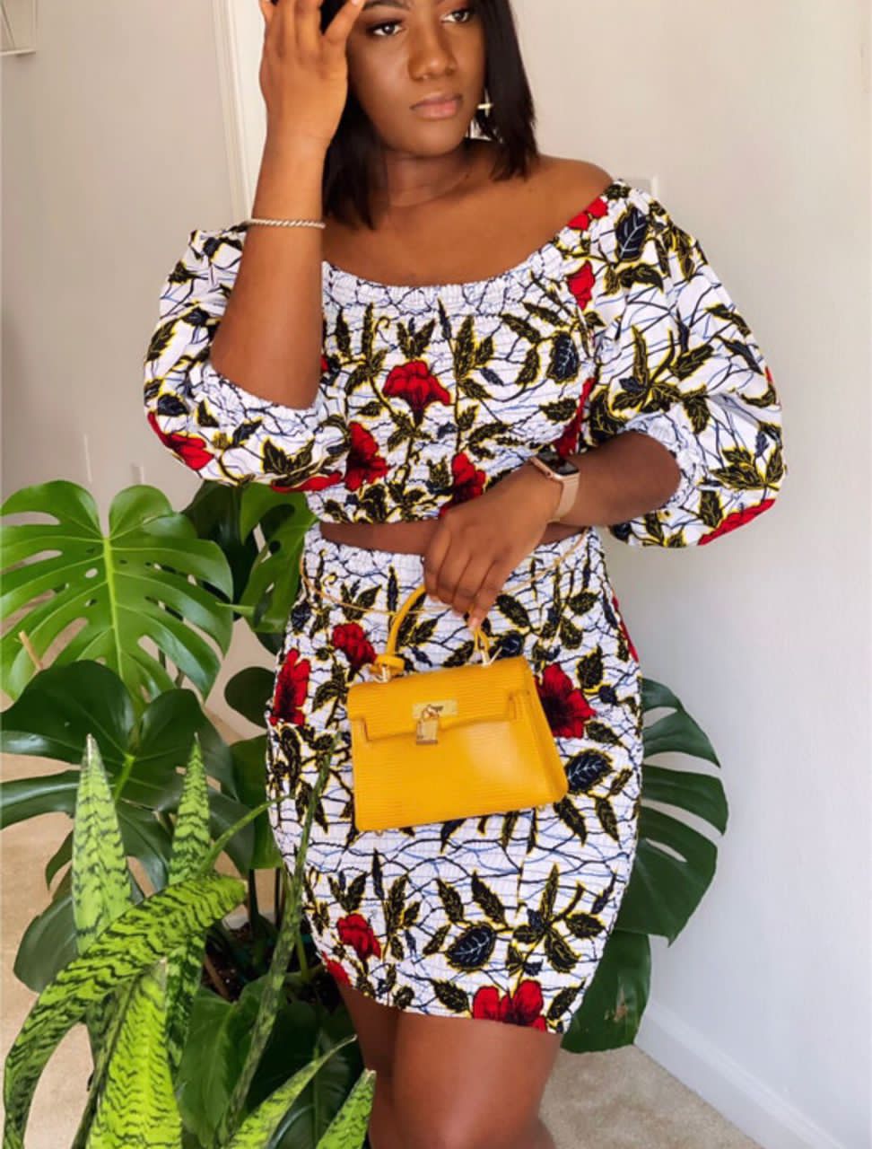 A stretchy two piece short skirt and a quarter sleeve puff hand top made with Ankara wax print/fabric designed with white, black gold and red beautiful 🌹colours and pattern