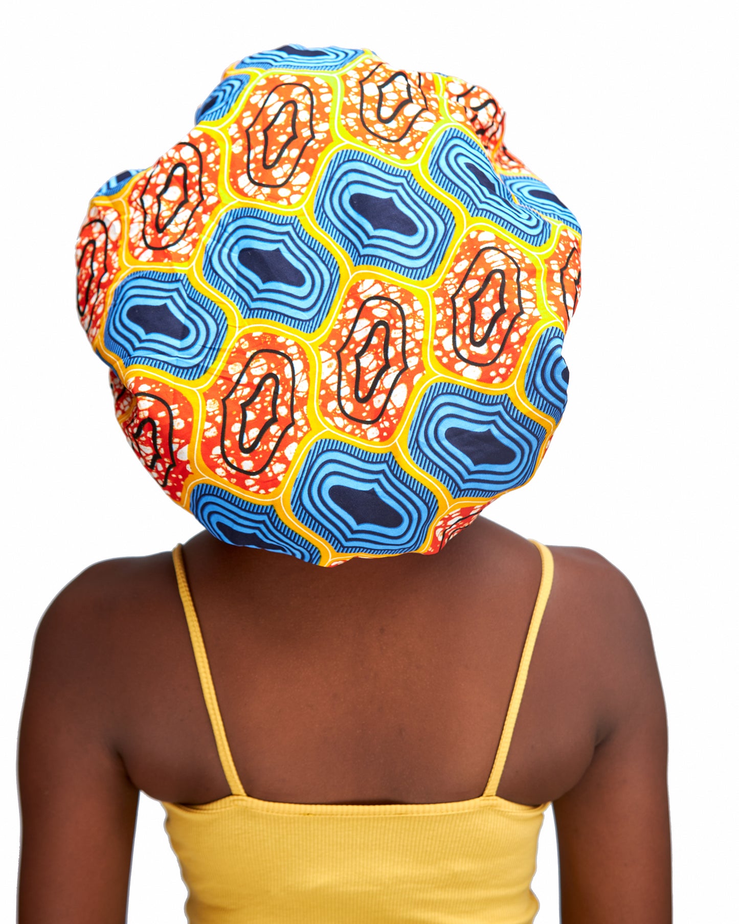 An Ankara Wax Print Made of Orange,White, Yellow, Seablue And Black Blend of Beautiful Colours And Pattern, Hand Made Elastic With Yellow Silk lined Hair Bonnet
