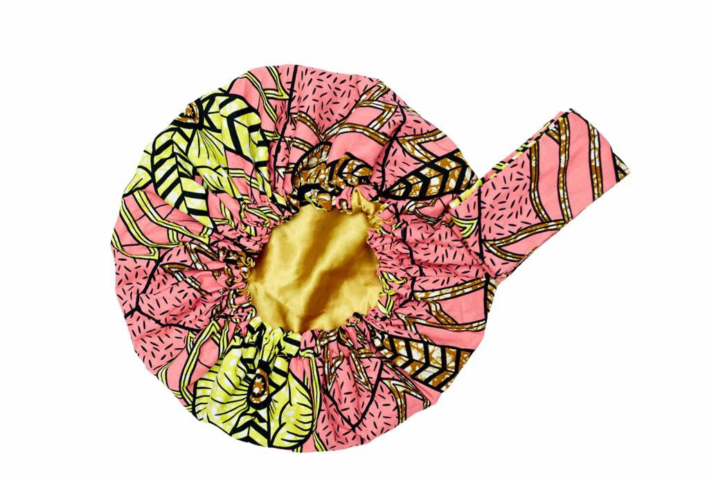 An Ankara African Print Made of Pink, yellow, Black and Curry Blended Beautiful Colours, Hand Made Elastic Silklined Bonnet With Band