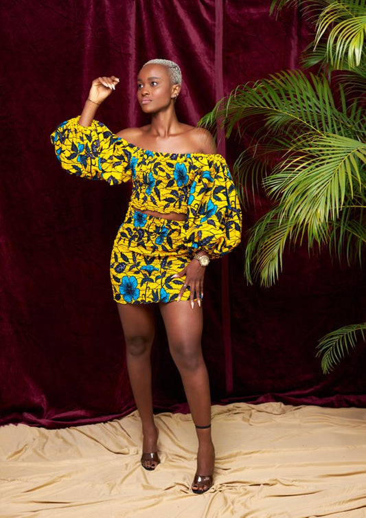 A stretchy two piece short skirt and a quarter sleeve puff hand top made with Ankara wax print/fabric designed with yellow, black and seablue beautiful 🌹colours and pattern