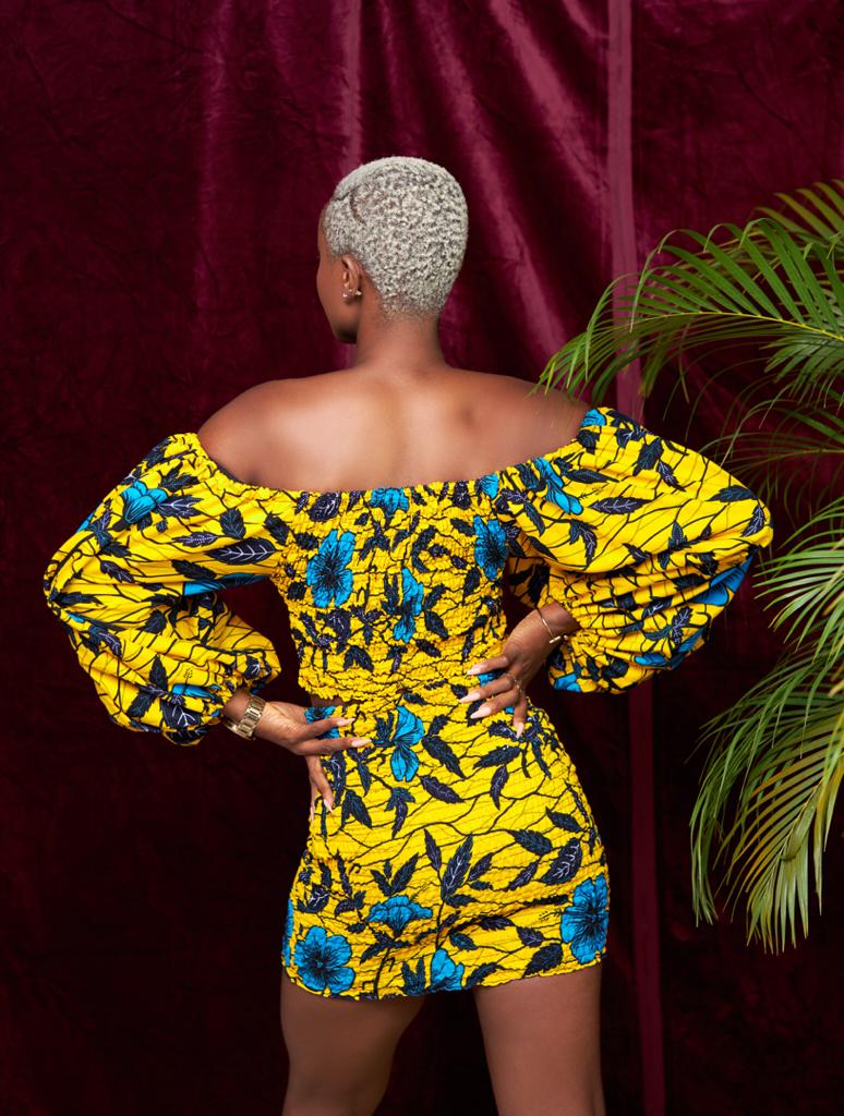 A stretchy two piece short skirt and a quarter sleeve puff hand top made with Ankara wax print/fabric designed with yellow, black and seablue beautiful 🌹colours and pattern 