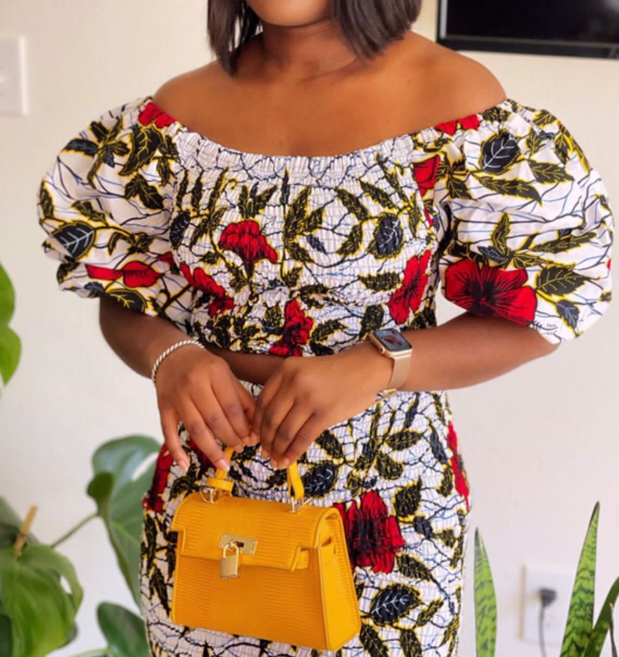 A stretchy two piece short skirt and a quarter sleeve puff hand top made with Ankara wax print/fabric designed with white, black gold and red beautiful 🌹colours and pattern 