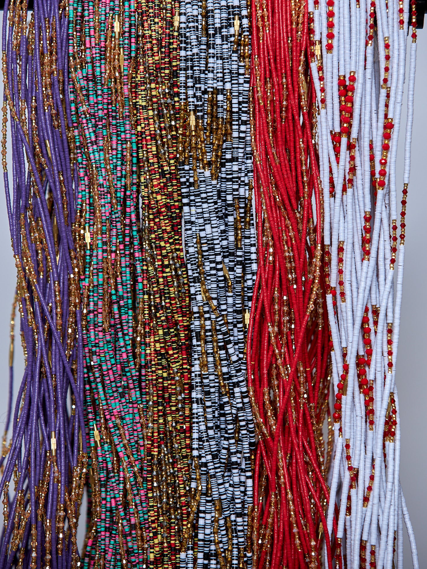 6 Different Colored typed of waist beads Including 52 Inches White And Black Vinyl Beads With Gold Glass Beads And Brown Pebble Bar Removable Screw Waist Beads, 53 Inches Pink , Black And Green Vinyl Beads With Gold Glass Beads And Light Brown Pebble Bar Removable Screw Waist Beads And 54 Inches Purple Vinyl Beads With Gold Glass Beads And Light Brown Pebble Bar Removable Screw Waist Beads