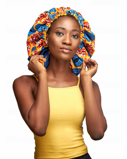 An Ankara Wax Print Made of Orange,White, Yellow, Seablue And Black Blend of Beautiful Colours And Pattern, Hand Made Elastic With Yellow Silk lined Hair Bonnet